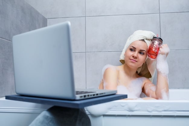 A person gently washing their face with a foaming cleanser in a brightly lit bathroom. The focus is on the hands and the face as the cleanser is being applied. The background is clean and modern, suggesting a focus on skincare.