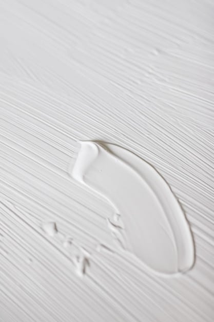 Close-up of three essential skincare products: a gentle cleanser, a lightweight moisturizer, and a broad-spectrum sunscreen. The products are displayed on a clean white surface with soft, natural lighting to emphasize their simplicity and effectiveness.