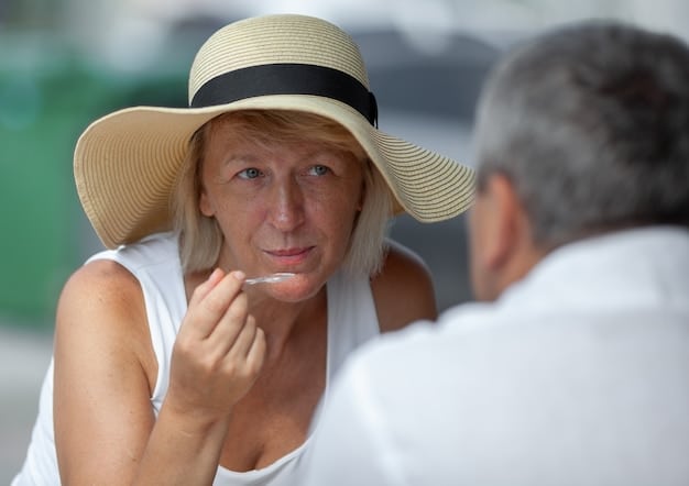 A woman applying sunscreen to her face. She is outdoors, wearing a hat and sunglasses. The focus is on the act of applying sunscreen as a preventive measure.