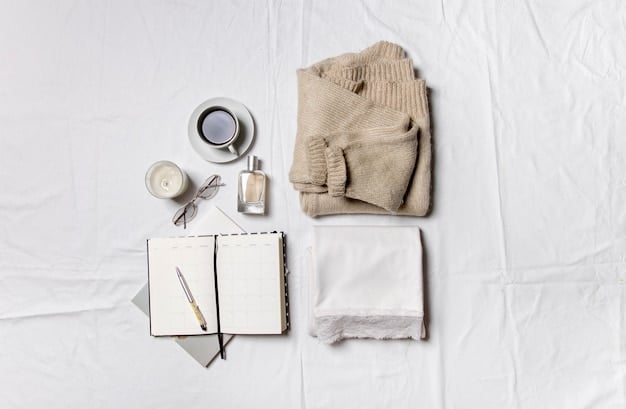 A close-up shot of five essential clothing items laid out on a clean, white surface: a crisp white button-down shirt, well-fitted dark wash jeans, a versatile black blazer, a comfortable gray knit sweater, and a pair of neutral-toned ankle boots. Each item is neatly arranged and well-maintained.