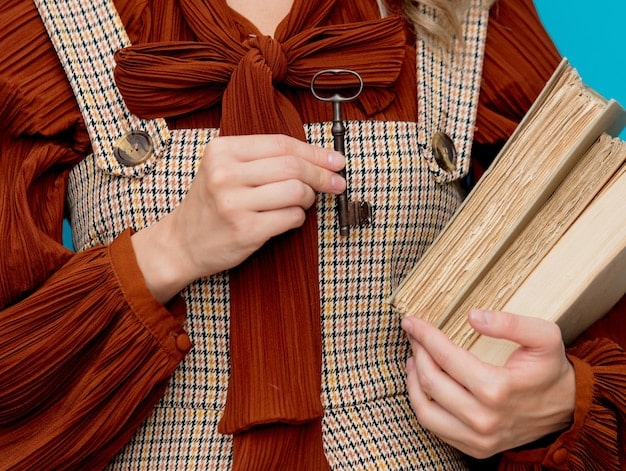 Close-up shot of a woman carefully inspecting a vintage dress at a clothing swap. The dress is brightly colored and has unique detailing, highlighting the potential for discovering hidden gems at these events.