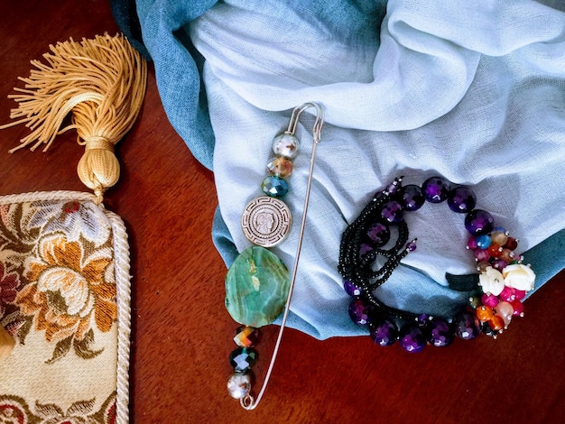 Close-up shot of a variety of fashionable and affordable accessories, including colorful scarves, statement earrings, and a selection of belts displayed on a neutral background.