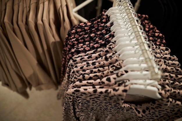 A close-up shot of a well-organized rack of high-end designer dresses in a consignment shop. The dresses are neatly arranged and feature various colors, fabrics, and styles. The lighting is soft and the focus is on the quality and craftsmanship of the clothing.
