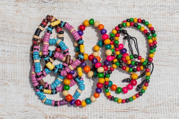 A close-up shot of various affordable accessories like colorful scarves, beaded bracelets, a simple necklace, and a stylish belt, arranged creatively on a wooden surface.