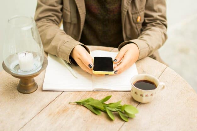 A person setting a timer on their phone next to a cup of tea and a meditation cushion, illustrating how to incorporate mindfulness into a daily routine.