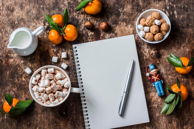 A notepad and pen resting on a desk, surrounded by healthy snacks and a water bottle, symbolizing the process of planning and setting wellness goals.