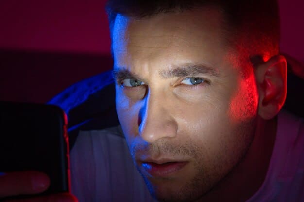 A close-up of an eye reflecting the blue light emitted from a smartphone screen, highlighting the potential strain and disruption caused by blue light.