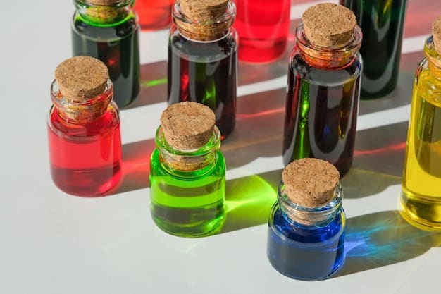 A close-up shot of several small bottles of essential oils, each with a different color cap and label indicating the type of oil (e.g., Lavender, Lemon, Peppermint), arranged on a wooden surface with soft natural lighting.